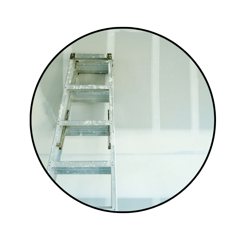 silver ladder leaning against a newly drywalled wall, ready for primer before paint