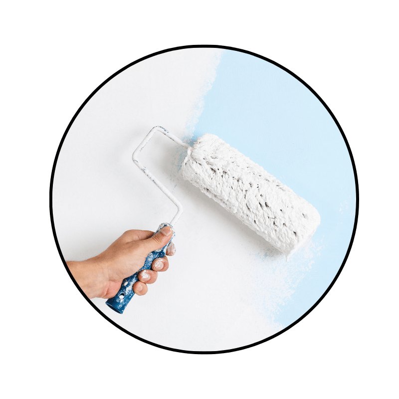paint roller and frame rolling out white paint on a previously blue wall